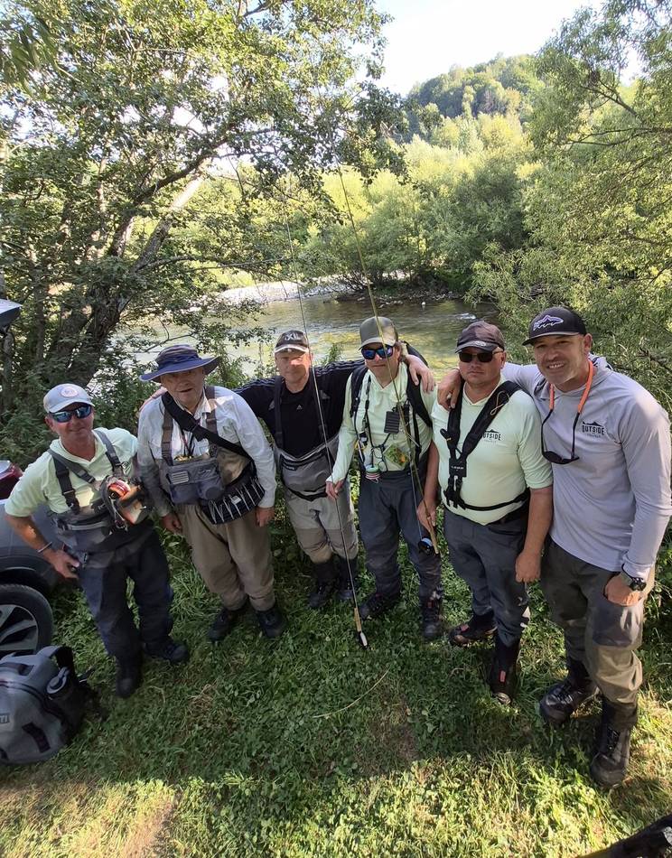 Six anglers and guides together by the river