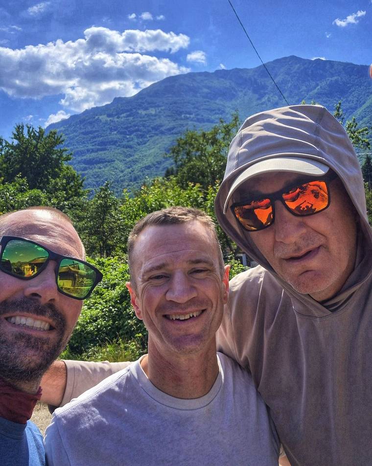 Three friends on a sunny day with the mountains behind