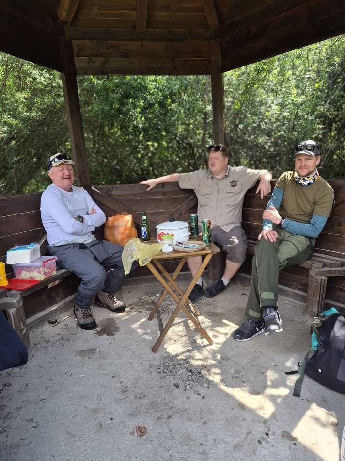 Anglers resting and eating in a wooden shelter