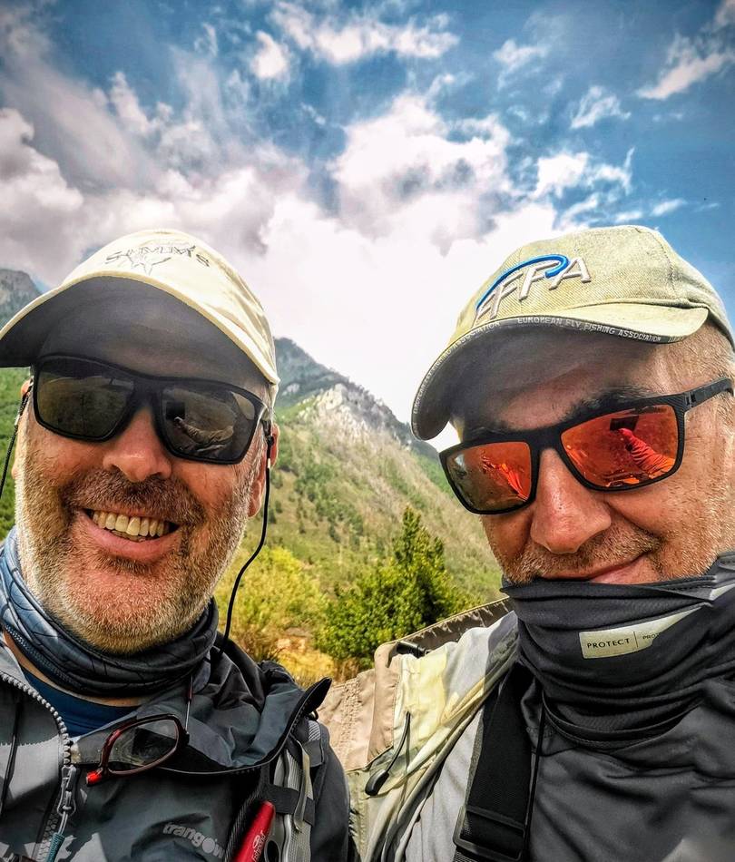 Two anglers in front of the mountains