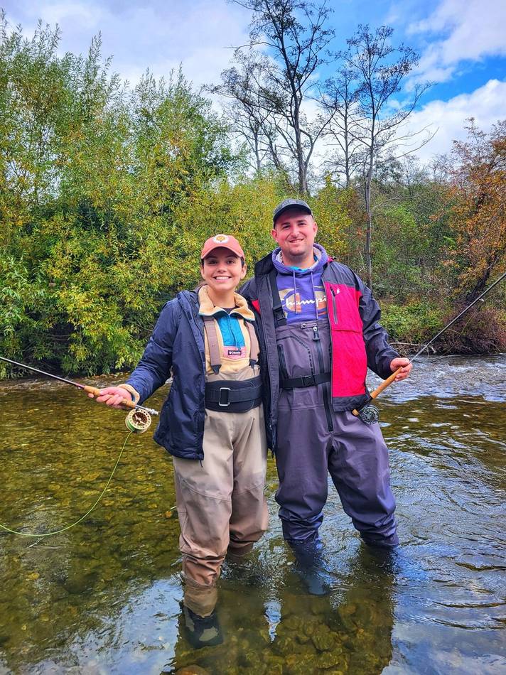 A couple fly fishing together in the river