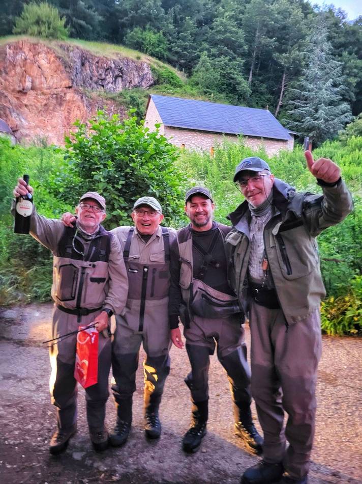 Four anglers celebrating after a day on the river