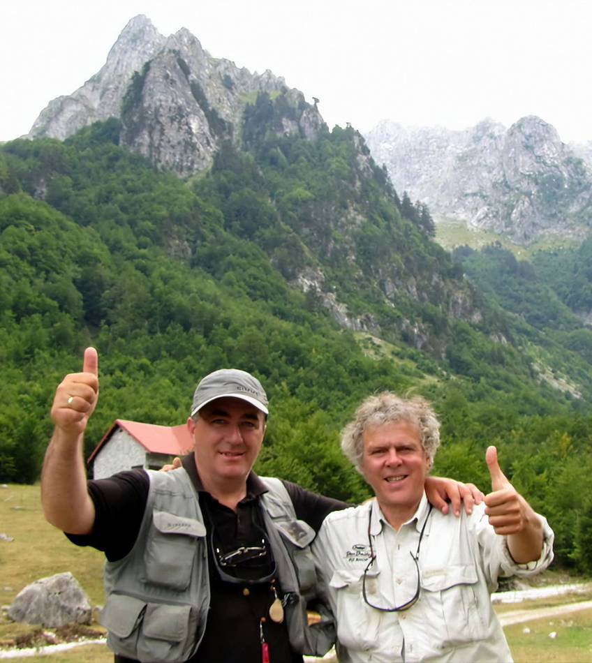 Two anglers giving thumbs up in front of the mountains