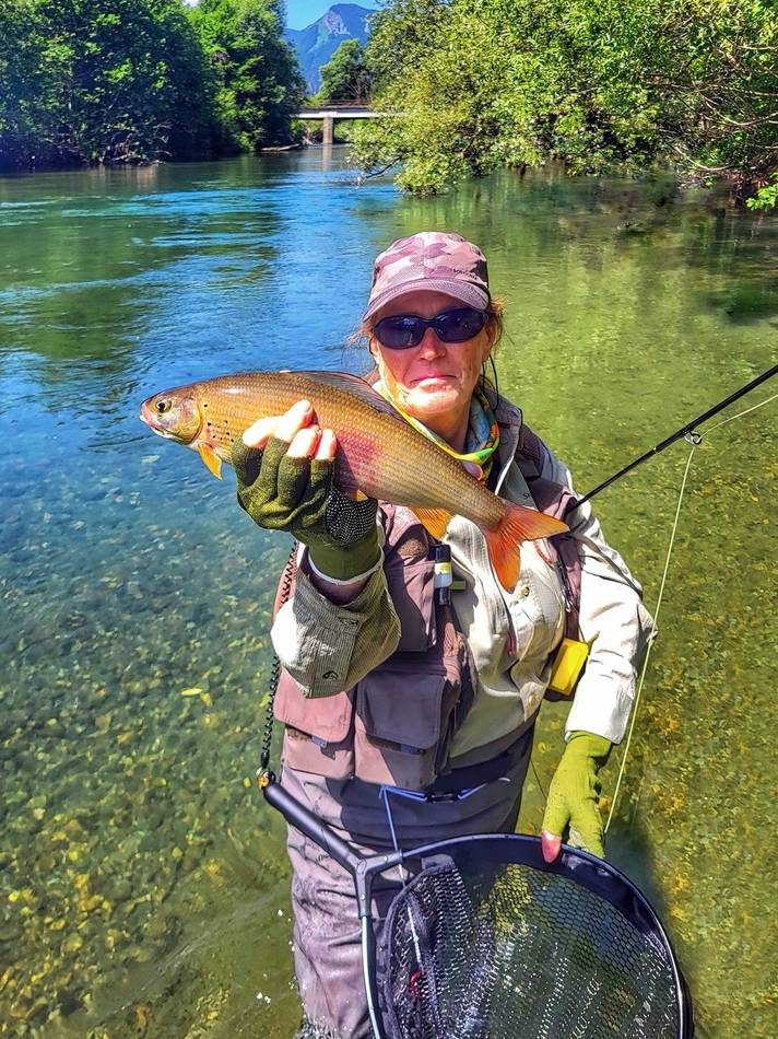 Two guests together with a grayling catch