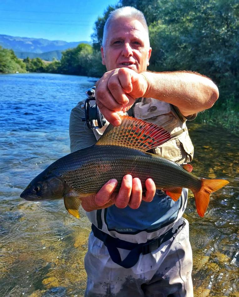 A young guest holding his spotted trout catch