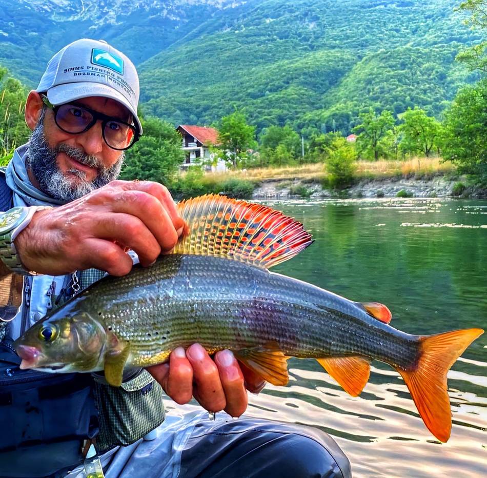 Two guests together with their grayling catch